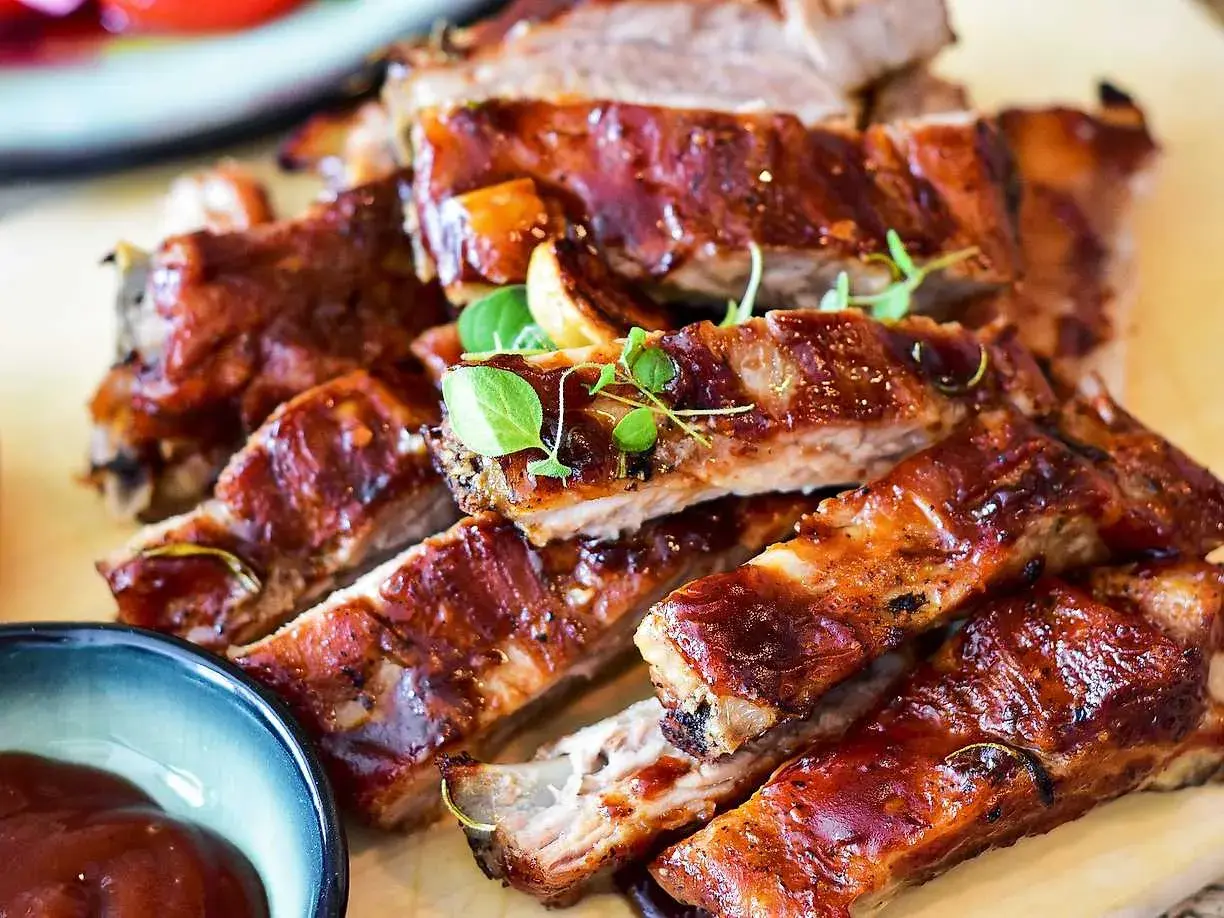Saftiga, glaserade spareribs med en mörk marinad, toppade med färska örter. Perfekt för grillkvällen!