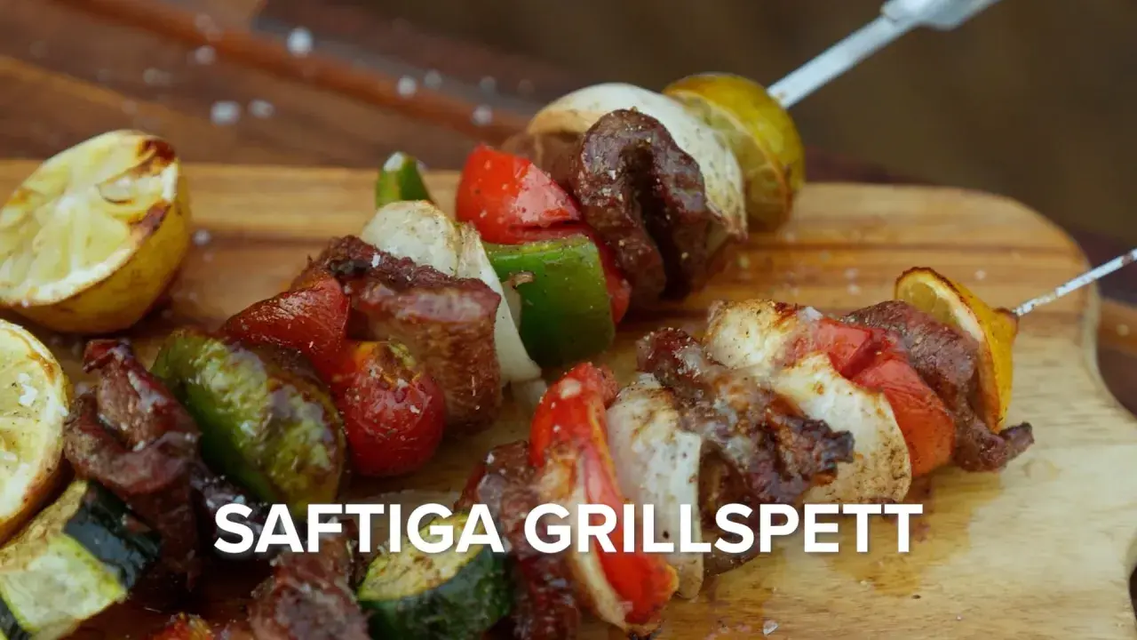 Saftiga grillspett med kött, grönsaker och citron på en träskärbräda. Perfekt för sommarens grillkvällar.